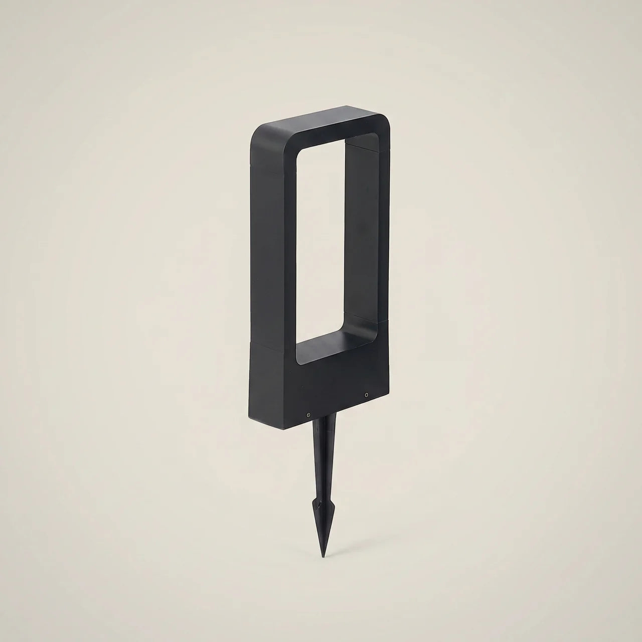 Side profile of matte black aluminum rectangular IP65 10W LED outdoor lawn light spike mount 23.6 inch height dimmed warm white glowing on path