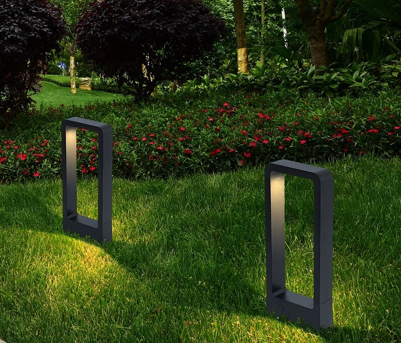 Matte black aluminum rectangular IP65 10W LED outdoor lawn light three-quarter angle spike mount 31.5 inch height glowing warm white on park path