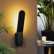 Modern Minimalist Nordic Wall Light Sconce next to a plant.