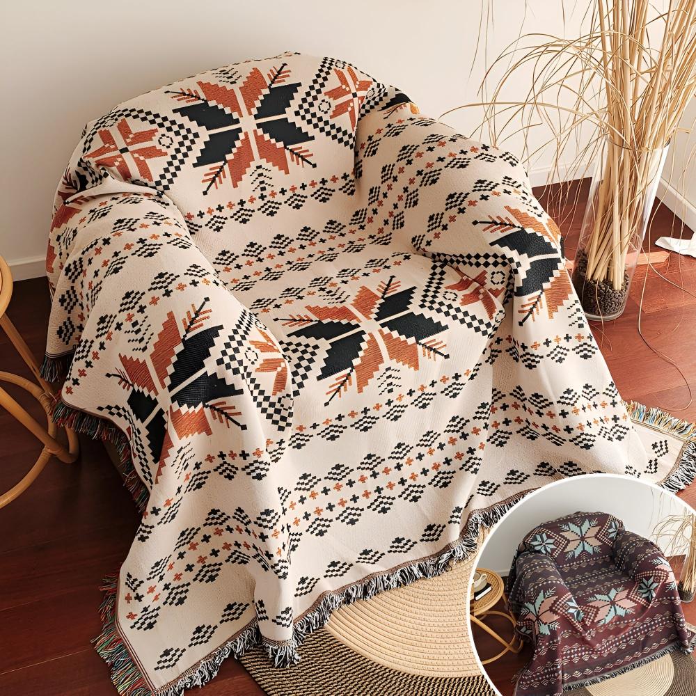 Nomad Oasis picnic blanket with Moroccan boho pattern draped over a rattan armchair, with an inset image showing a different color variant on a similar chair, demonstrating style options.