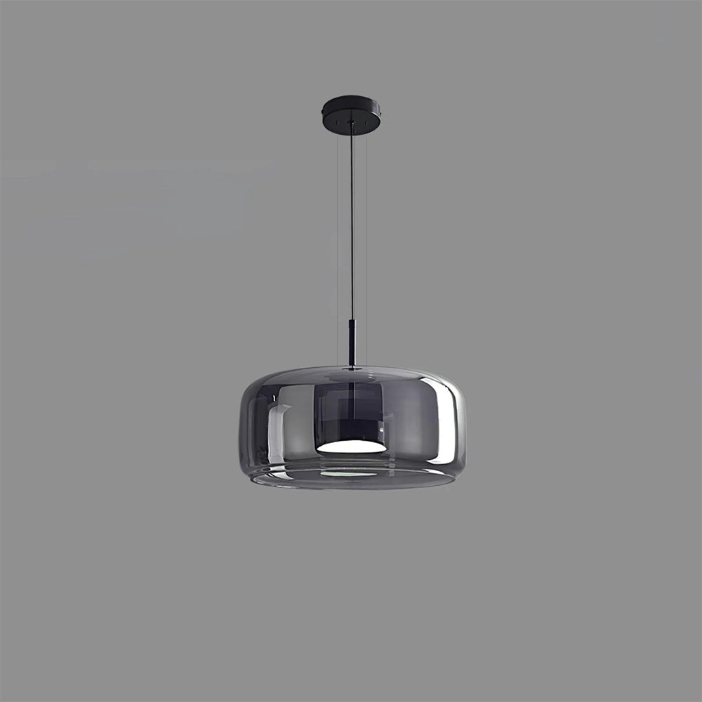 A single Nordic Glow smoked grey glass LED pendant light with a minimalist design, featuring a black canopy and internal fixture, illuminated with a white light against a plain grey background.