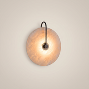 Natural marble black round warm LED wall sconce shown front view with 20cm diameter and warm light glowing