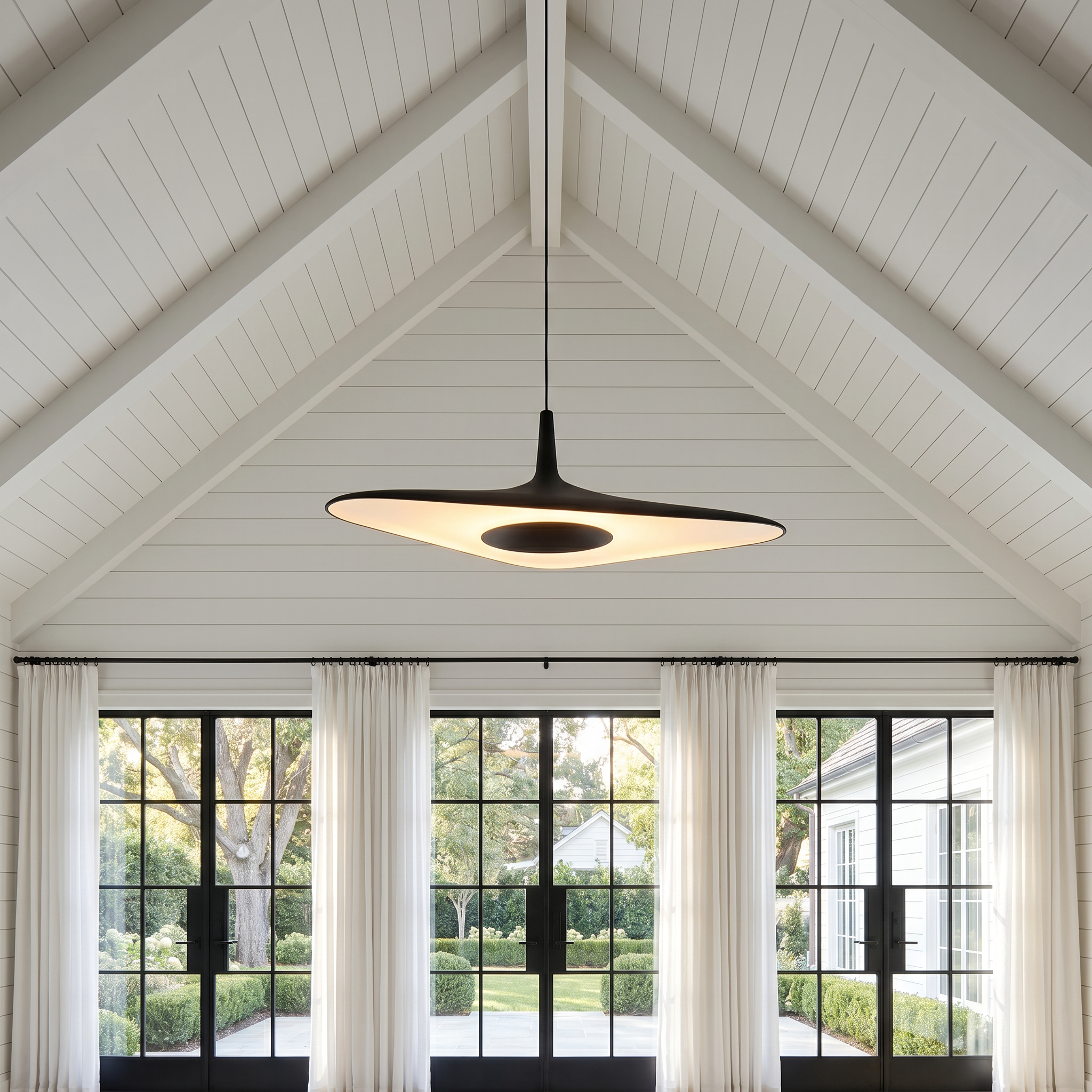 Nordic Art Pendant Light in white at three-quarter angle hanging in sunroom with tri-color LED lit
