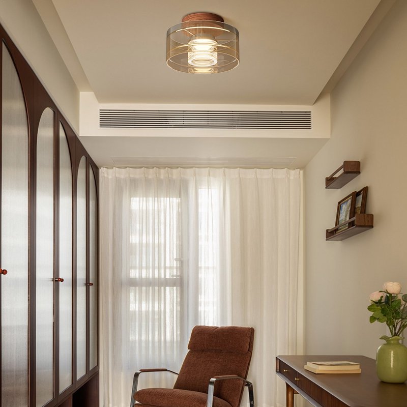 Modern Italian nickel aluminum LED ceiling light with nickel base front view showing clear glass shade glowing warm light