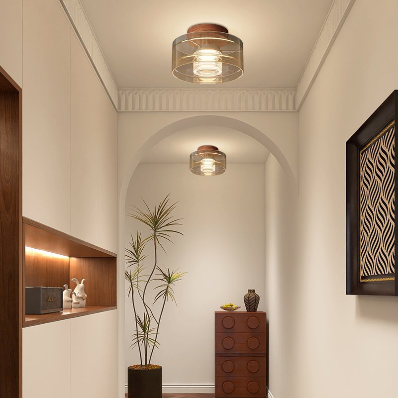 Modern Italian black aluminum LED ceiling light with black base three-quarter angle close-up glowing with even light