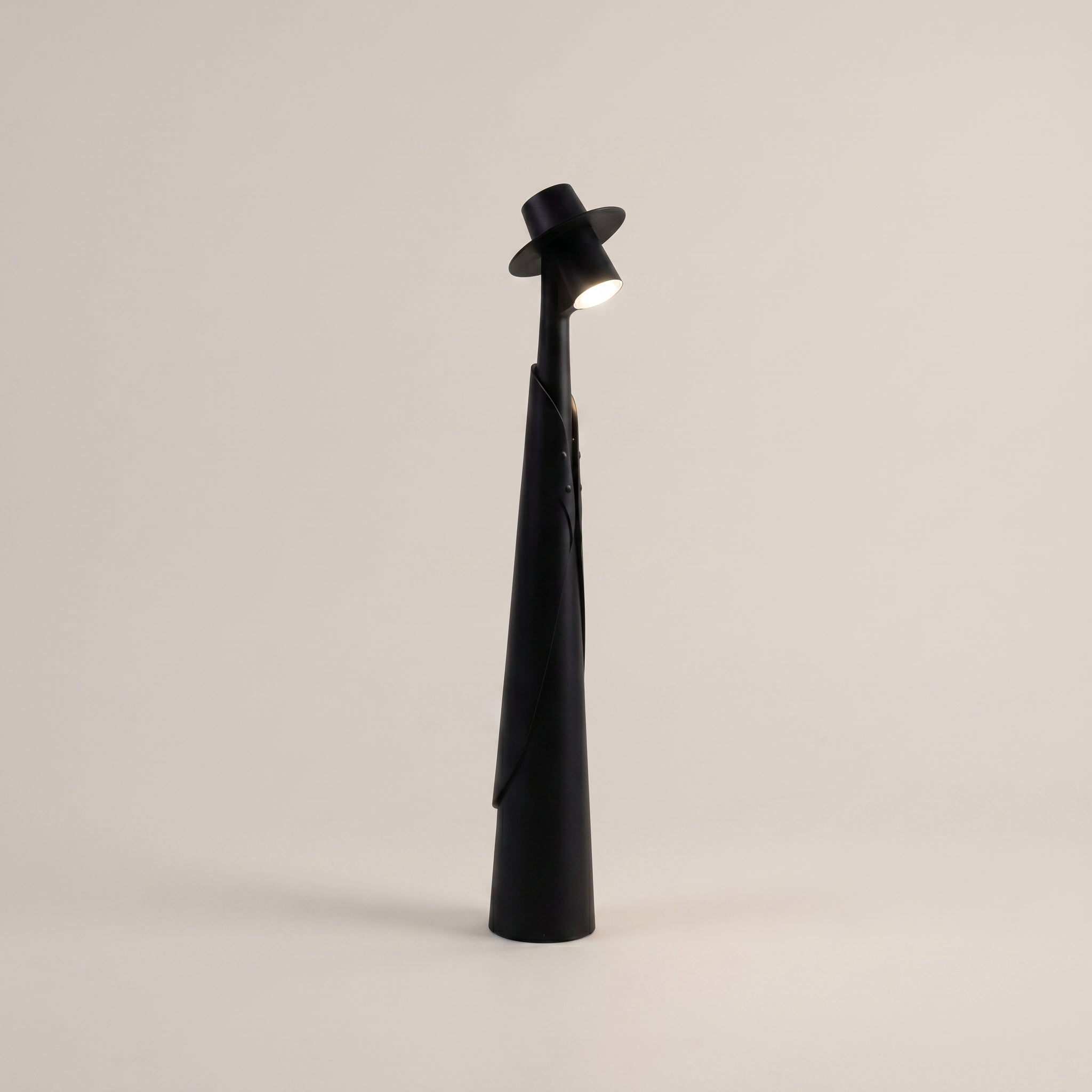 Black Plastic Tall Rechargeable LED Ambient Portable Table Lamp three-quarter angle lit on dining table