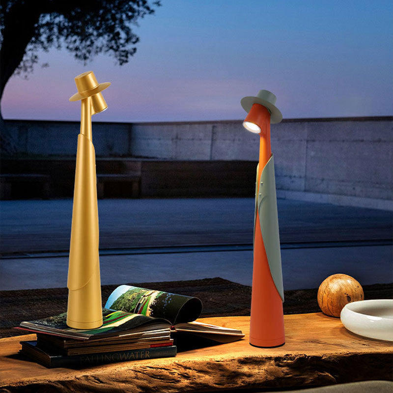 Gray Plastic Tall Rechargeable LED Ambient Portable Table Lamp side profile lit on study desk