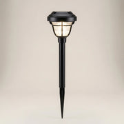 Ambient room three-quarter view of PP Round Solar Light Sensor with nickel-metal hydride battery glowing warm light with shadow projection effect