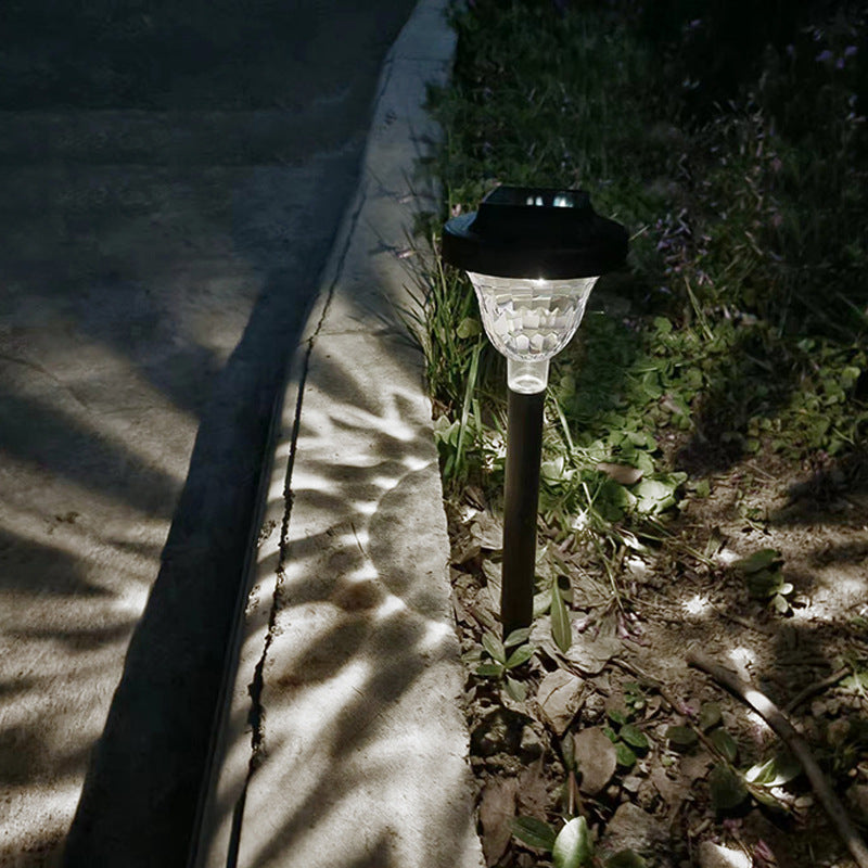 Close-up of PP Round Solar Light Sensor lit with cool white light showing shadow projection on garden flower bed