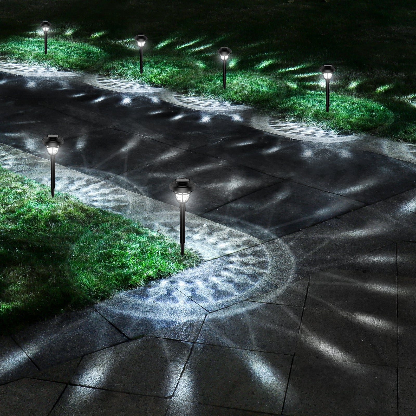 Three-quarter view of PP Round Solar Light Sensor lit with cool white light on garden patio area