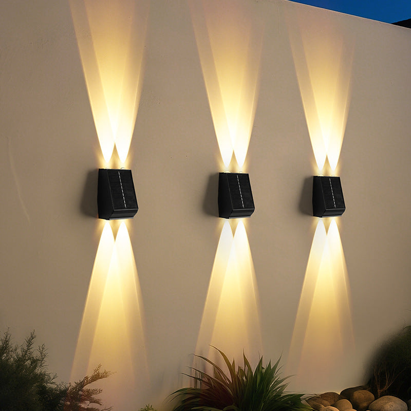 Front view of warm white light stainless steel aluminum 2-head solar motion sensor outdoor wall sconce with durable exterior