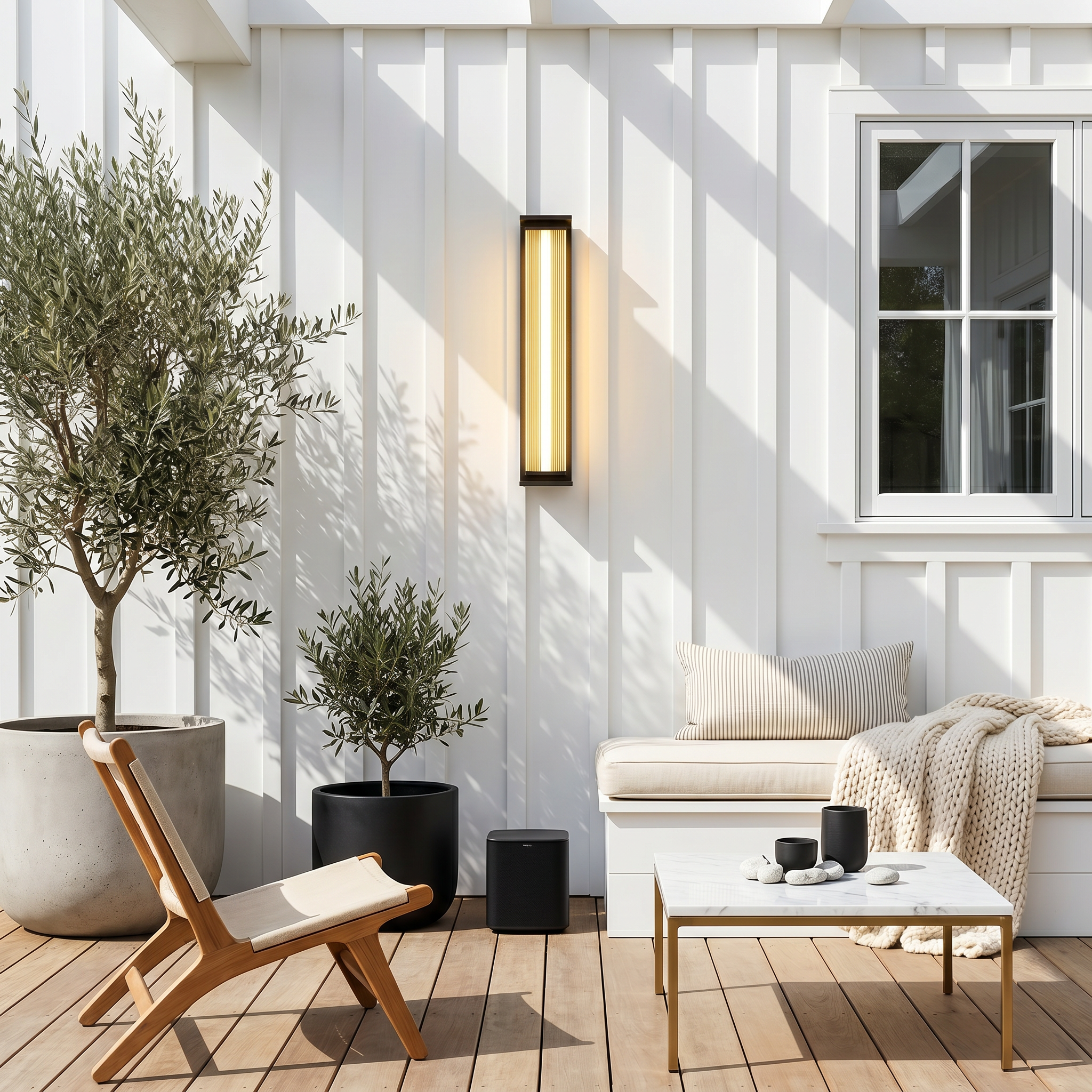 Balcony scene with stainless steel vertical ribbed waterproof LED outdoor wall sconce at three-quarter angle glowing neutral light with long rainbow acrylic