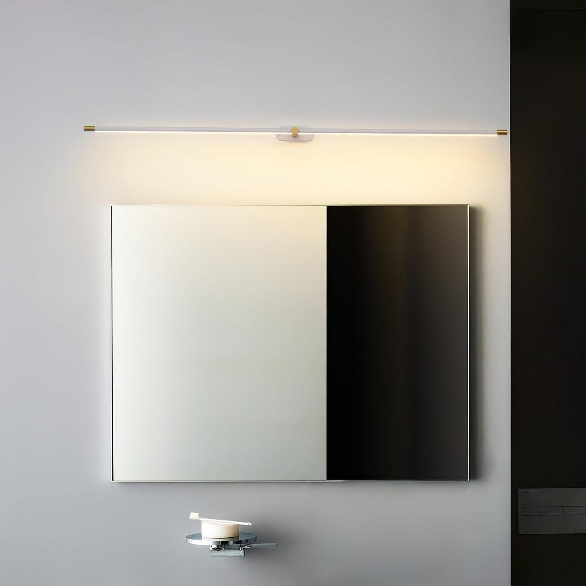 Vestra Minimalist Linear Rechargeable Wall Lamp Metal with LED Finish in gold, illuminated above a mirror in a modern bathroom setting.