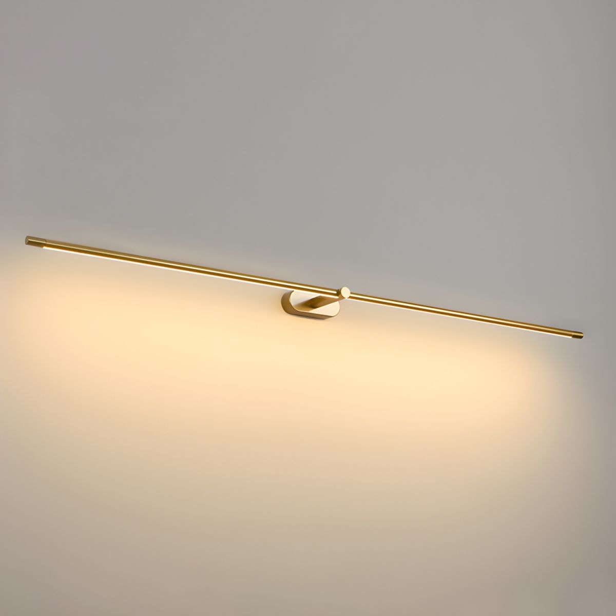 Vestra Minimalist Linear Rechargeable Wall Lamp Metal with LED Finish in gold, illuminated and casting a warm glow on a light gray wall.