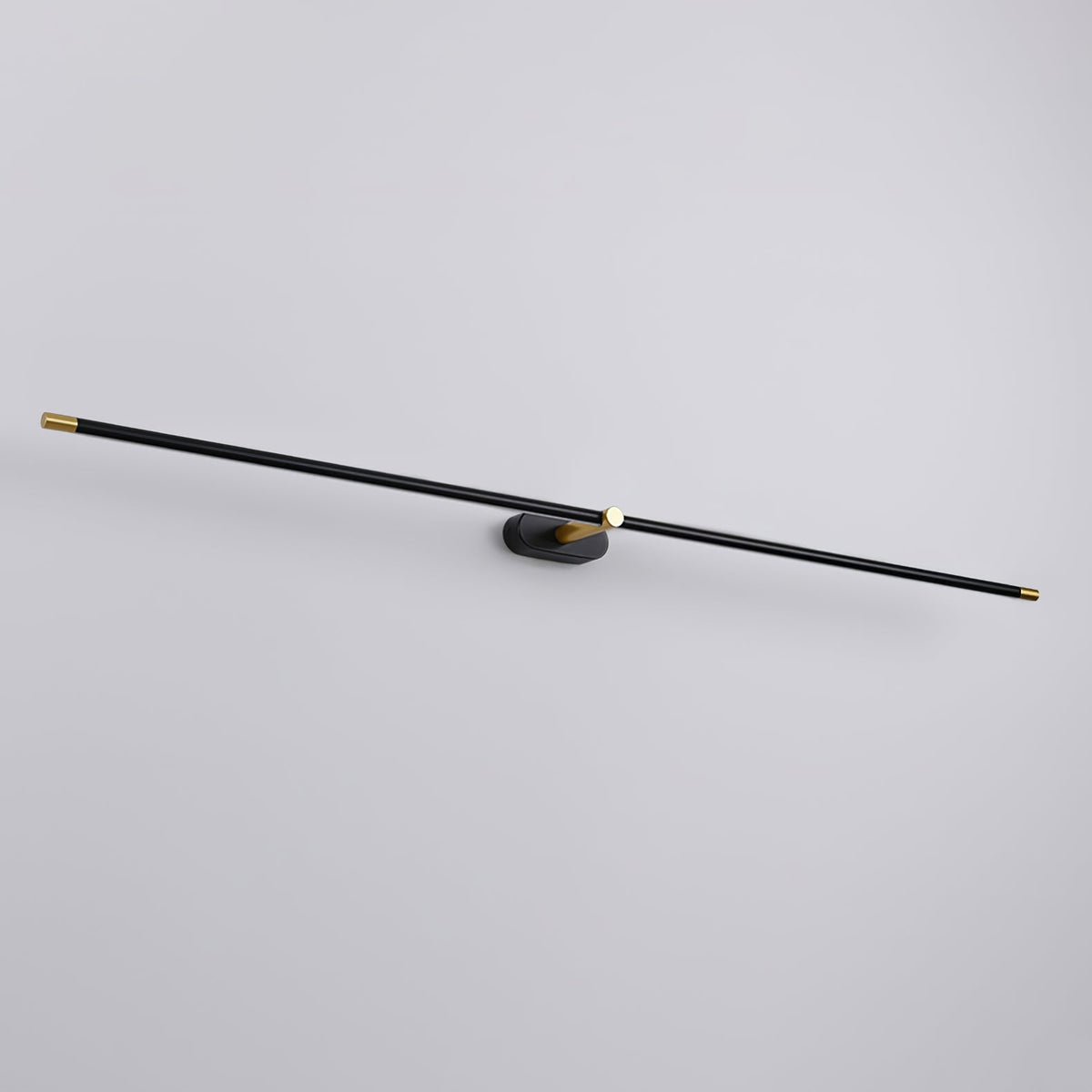A Vestra minimalist linear rechargeable wall lamp in black metal finish with gold accents, unlit, mounted on a light grey wall.