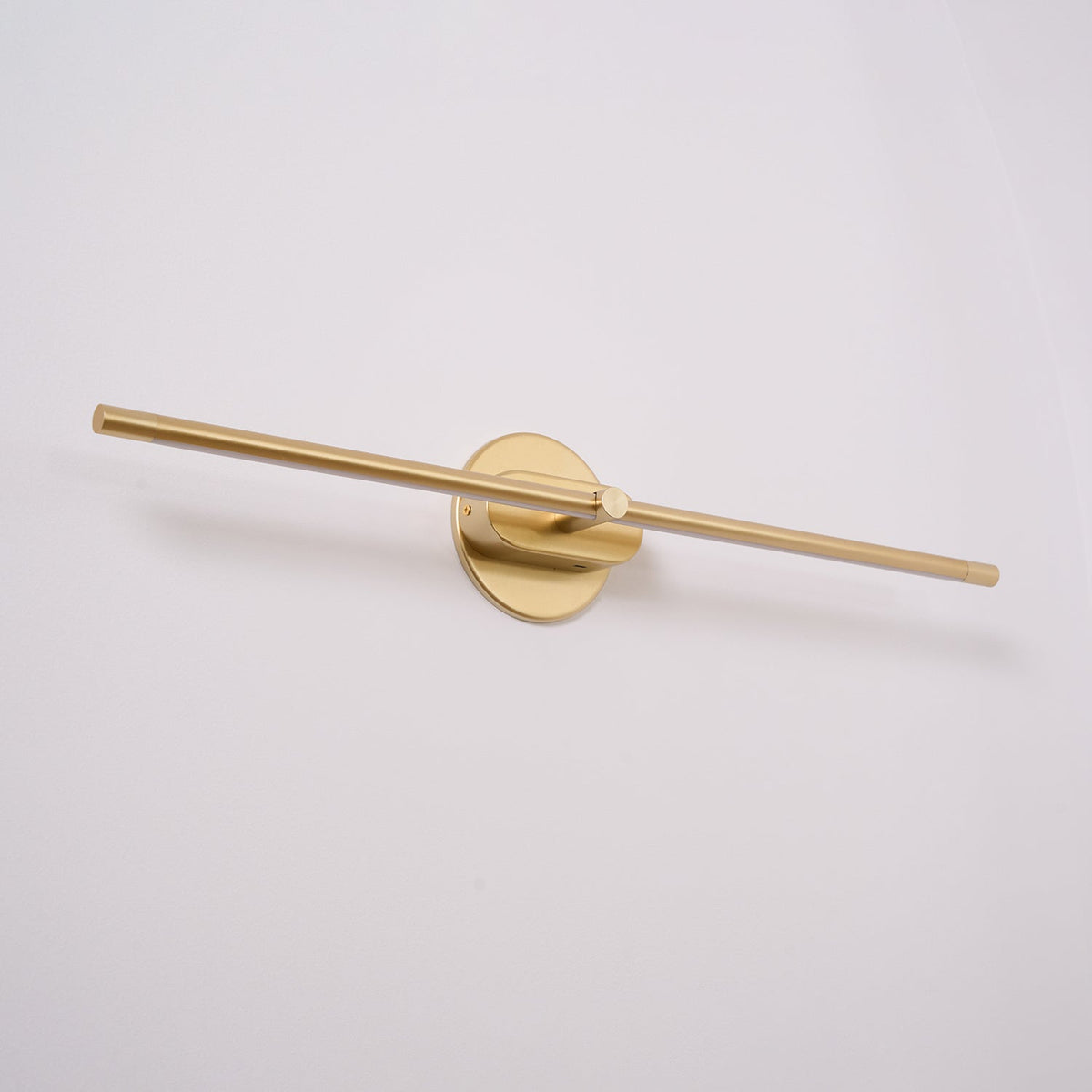Close-up of the Vestra Minimalist Linear Rechargeable Wall Lamp Metal LED Finish in gold, mounted on a white wall.