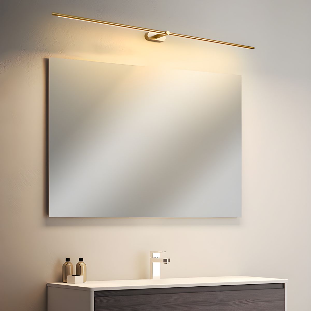 Vestra Minimalist Linear Rechargeable Wall Lamp in gold finish, illuminated and angled above a square mirror in a contemporary bathroom, demonstrating its versatile mounting options.