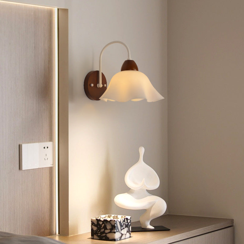 Close-up of walnut wood single-head mid-century wall sconce with walnut finish showing minimalist design details