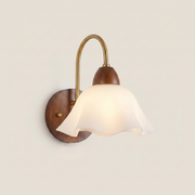 Close-up of walnut wood single-head mid-century wall sconce showing smooth walnut finish and wood grain texture