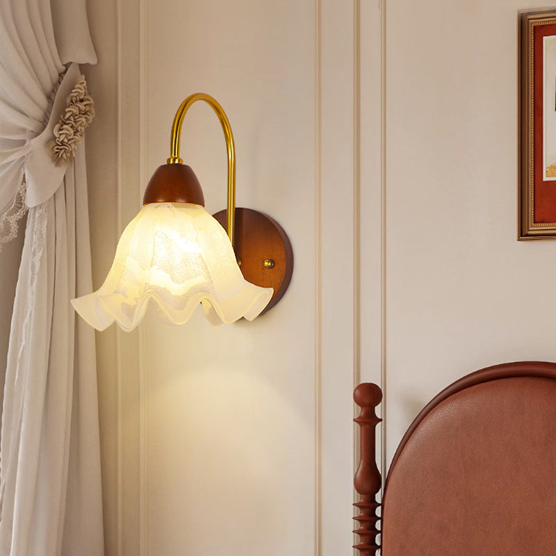 Three-quarter view of walnut wood single-head mid-century wall sconce with walnut finish showing mid-century modern style