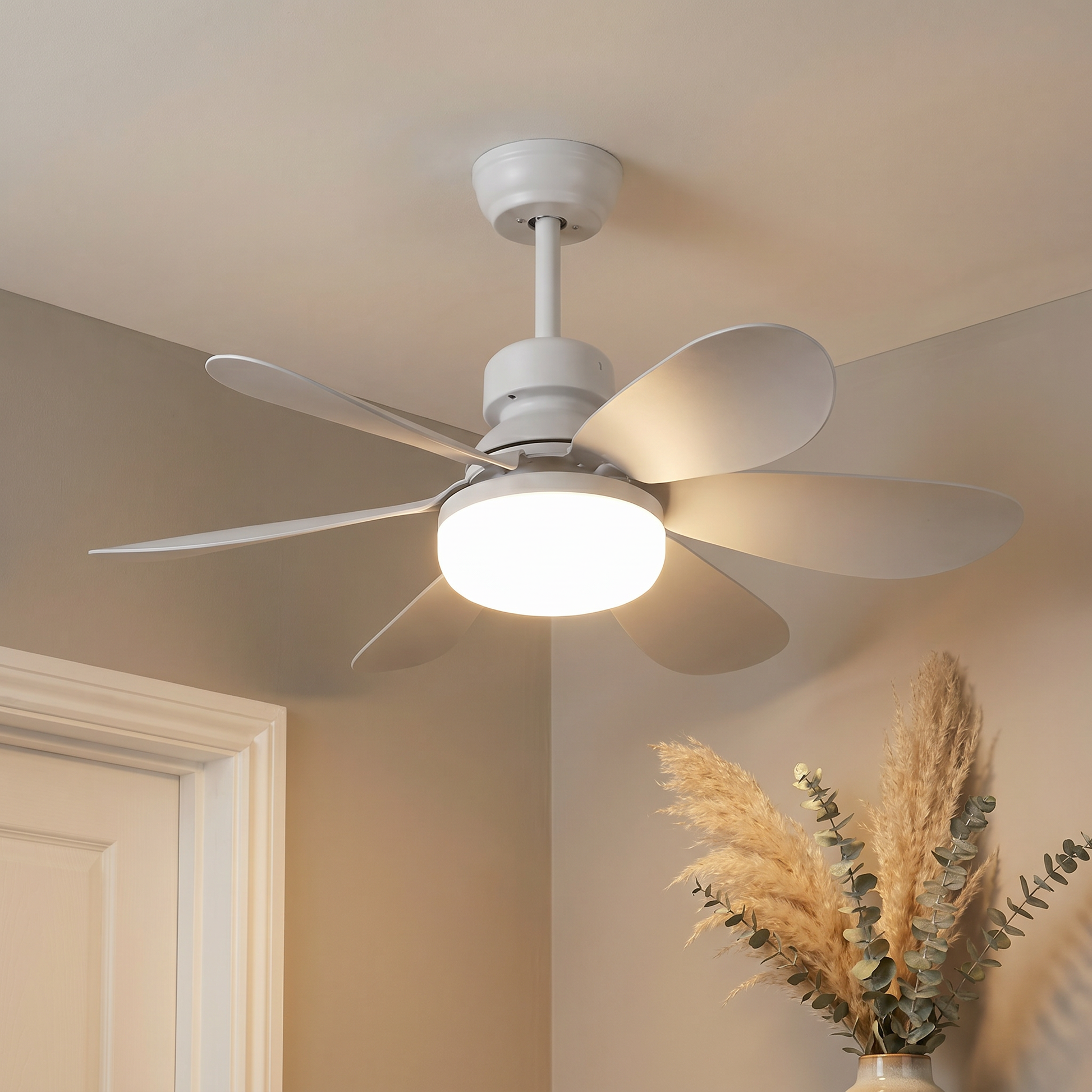 Side profile of white plastic round DC brushless motor ceiling fan light with white blades lit in an ambient dining room