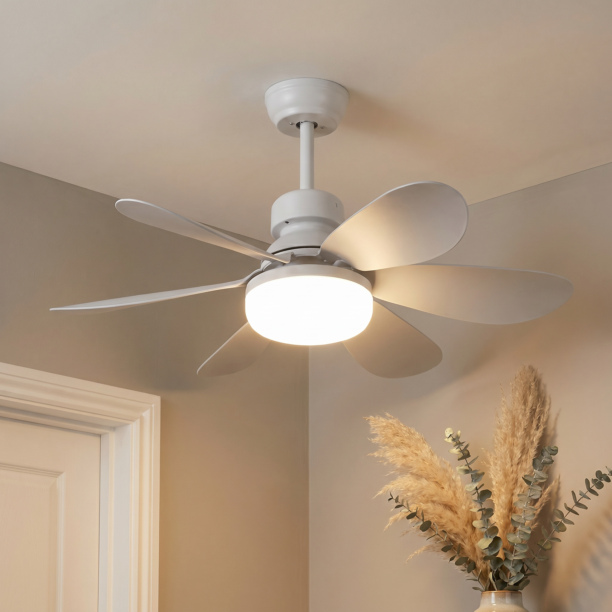 Side profile of white plastic round DC brushless motor ceiling fan light with white blades lit in an ambient dining room