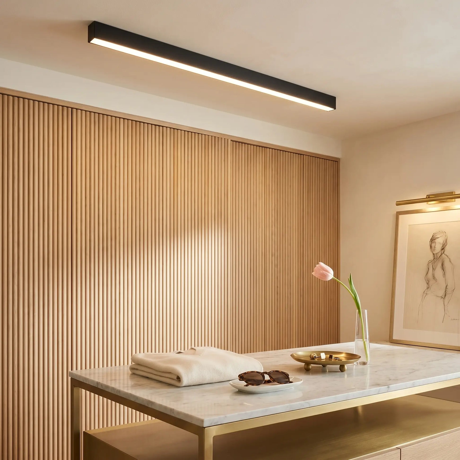 Ambient room view of modern minimalist aluminum sand white ceiling light dimmed linear strip with remote control visible