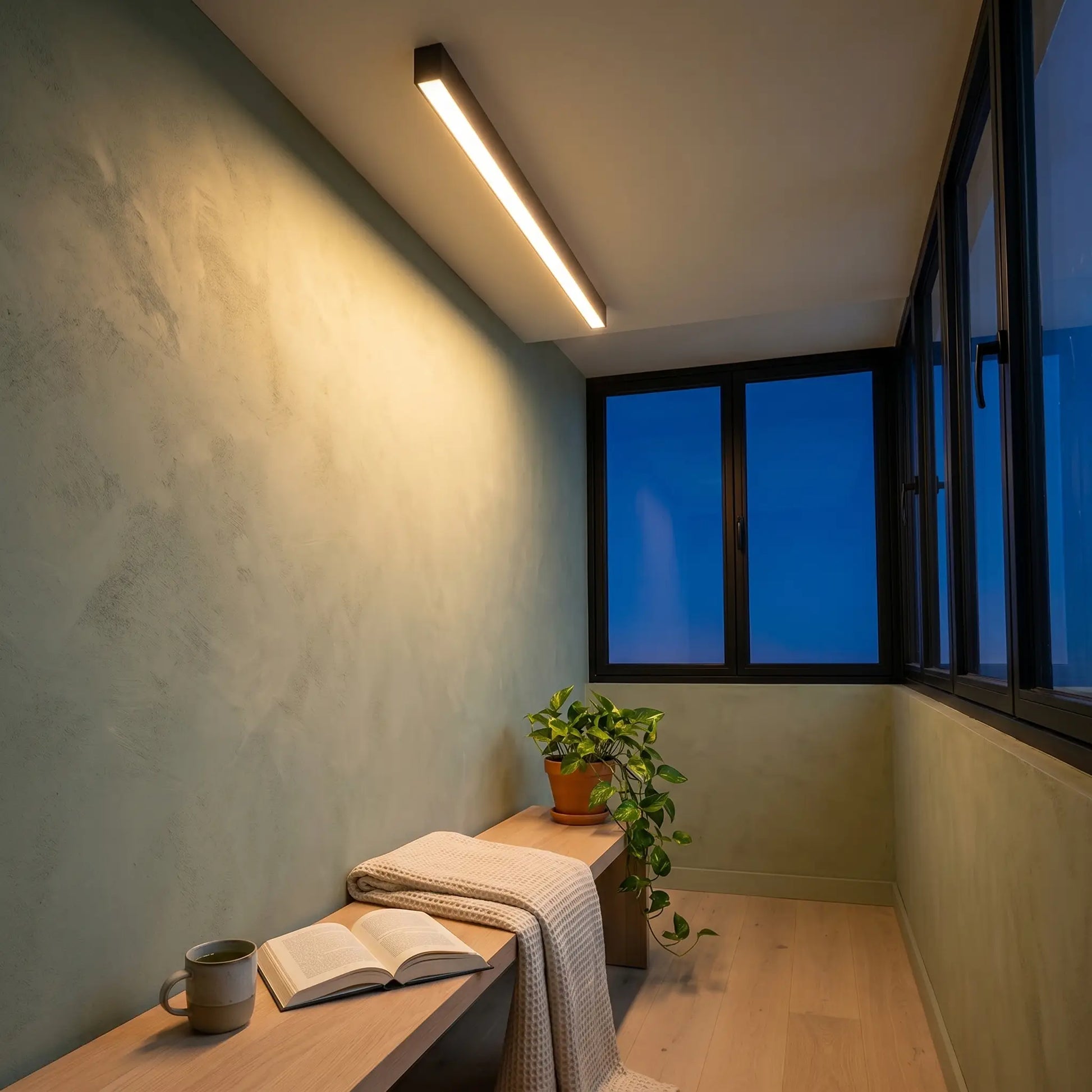Ambient room lit warm light view of modern minimalist aluminum sand white ceiling light with remote control and linear strip