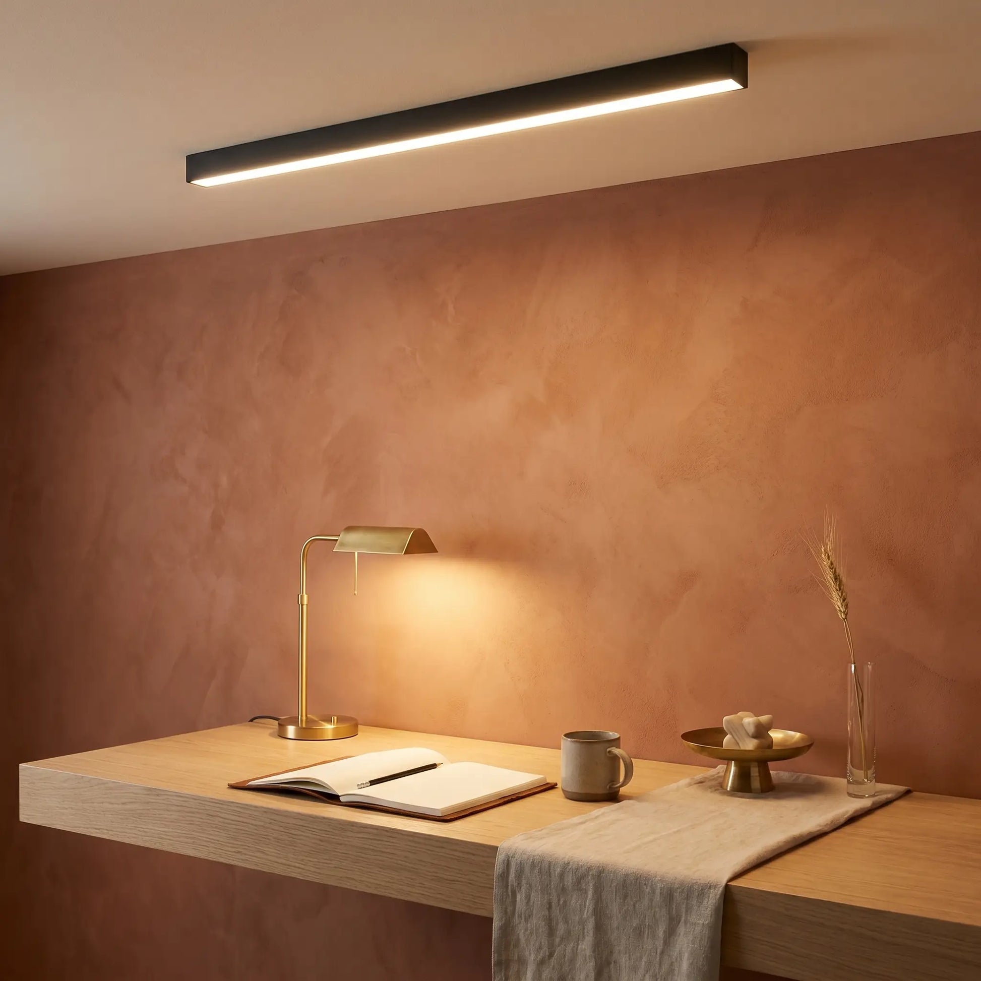 Ambient room view of modern minimalist aluminum sand white ceiling light off linear strip with remote control visible
