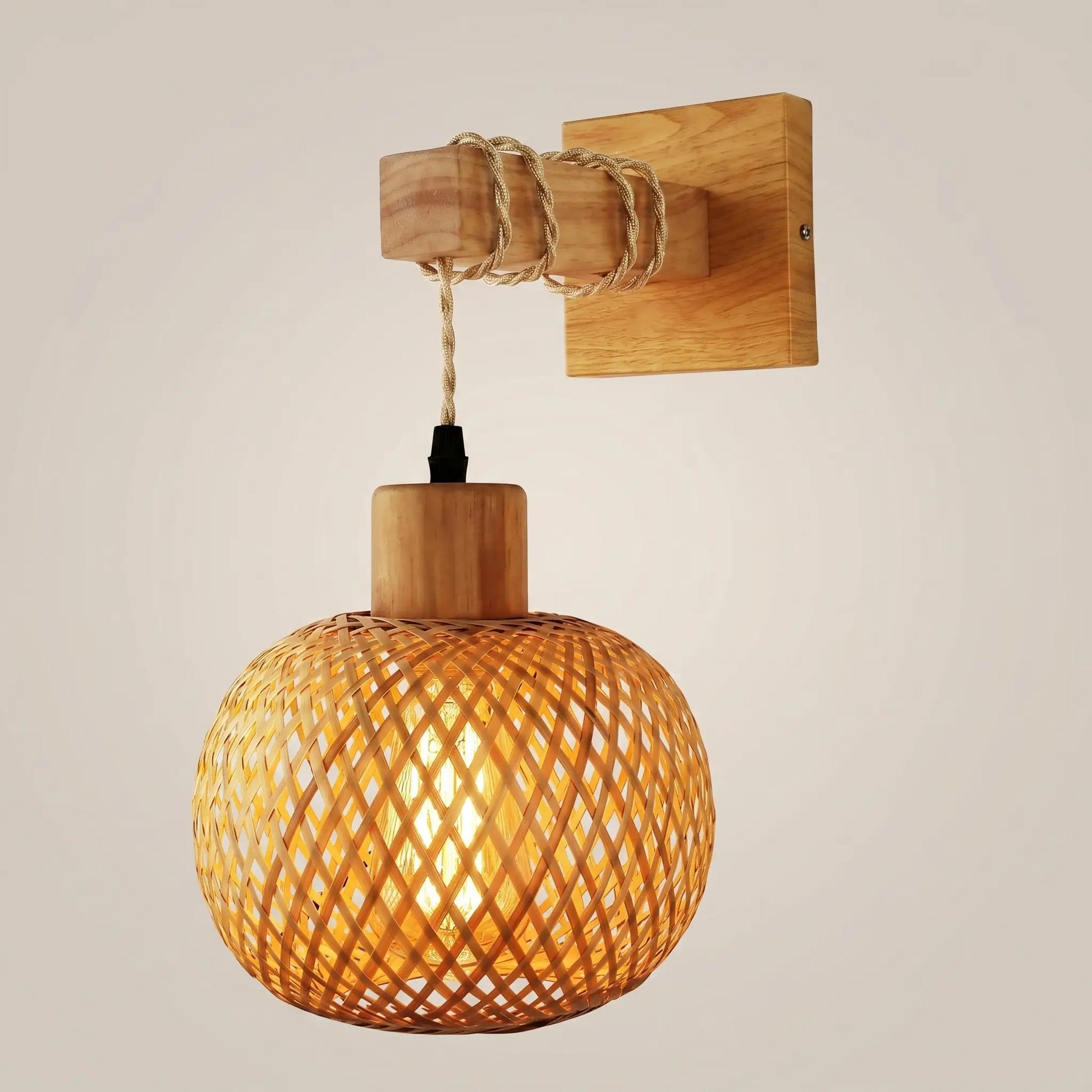 Pastoral bamboo wood spherical incandescent ceiling light front view with warm glow on natural wood frame and woven bamboo shade lit